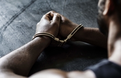 Man handcuffed - Felony crimes defense in Missouri
