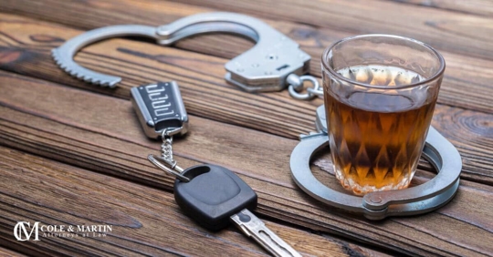 alcohol liquor drink in glass around handcuffs car keys dwi drunk driving charge