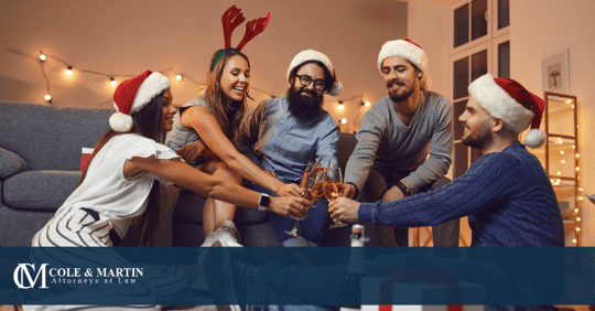 People gathered at a holiday party with drinks.