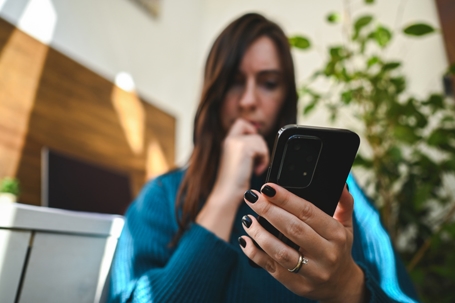 woman with phone in hand